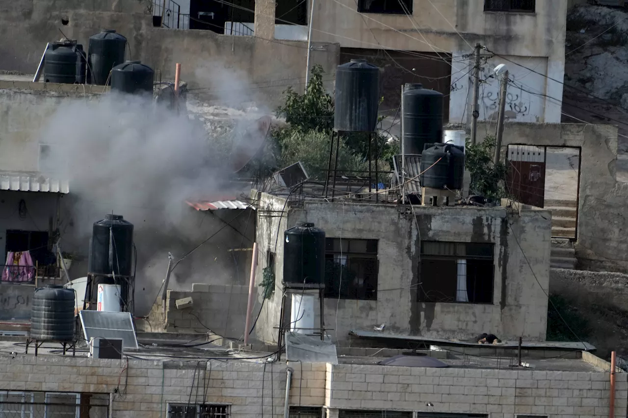 Israeli soldiers pushed three apparently lifeless bodies from roofs during a West Bank raid