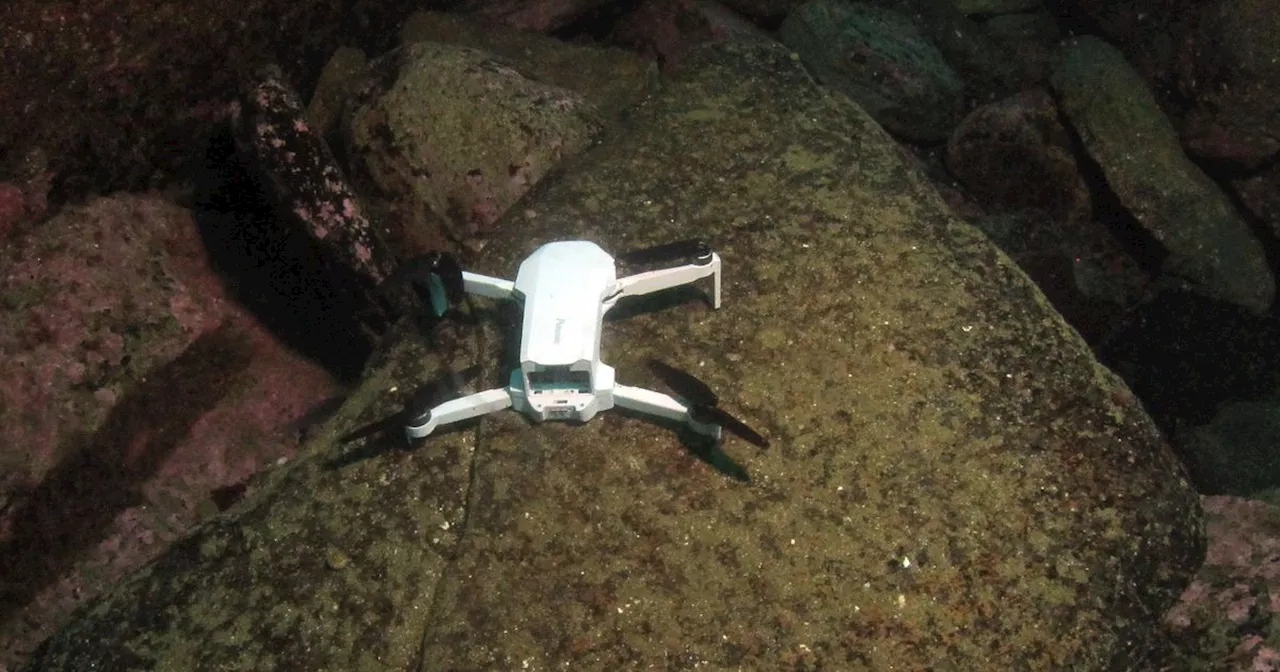 Drone found at seabed and divers recover videos in bid to reunite it with owners