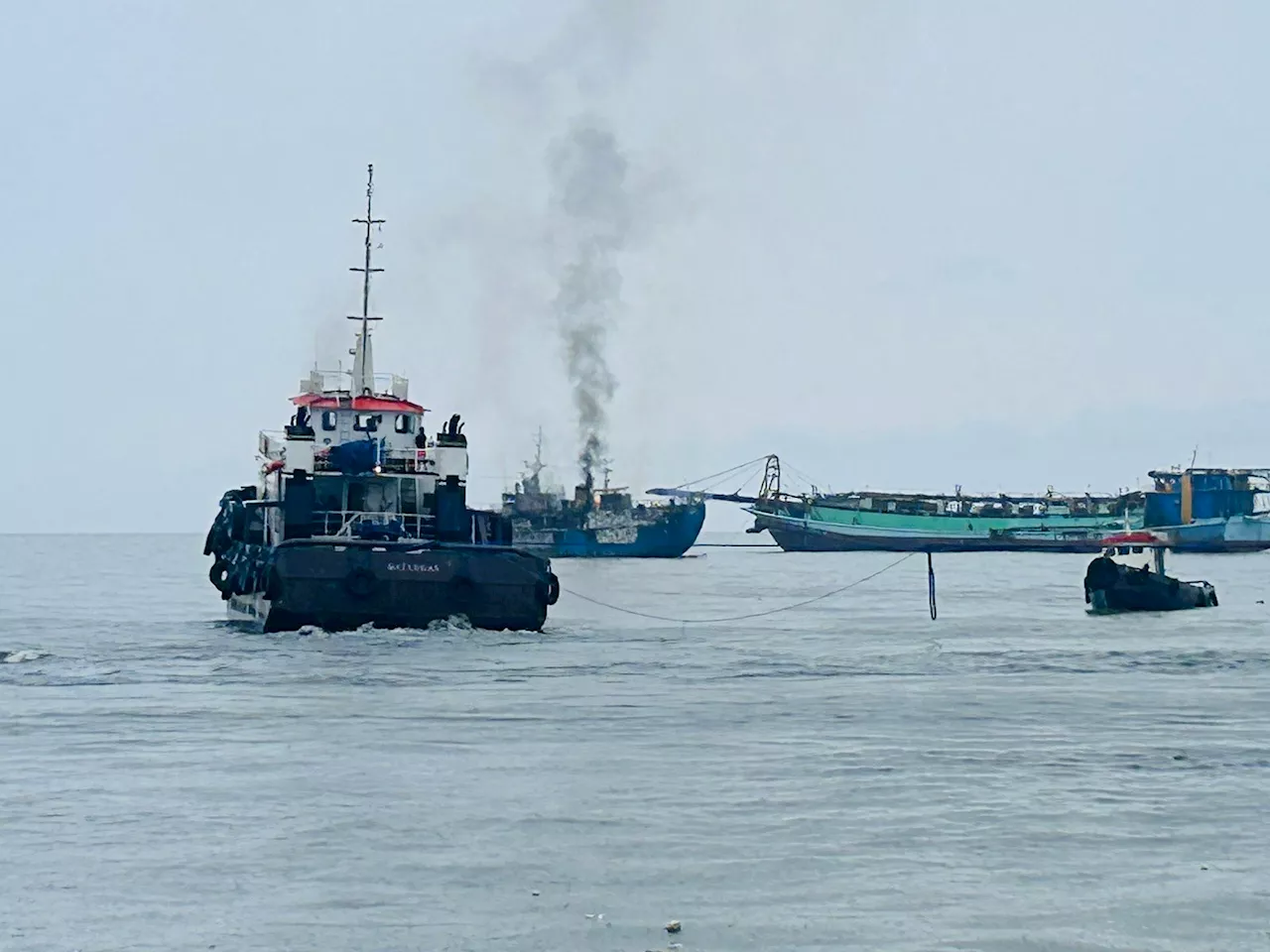 Amid storm, Coast Guard rescues crew after fire breaks out on ship in Manila Bay