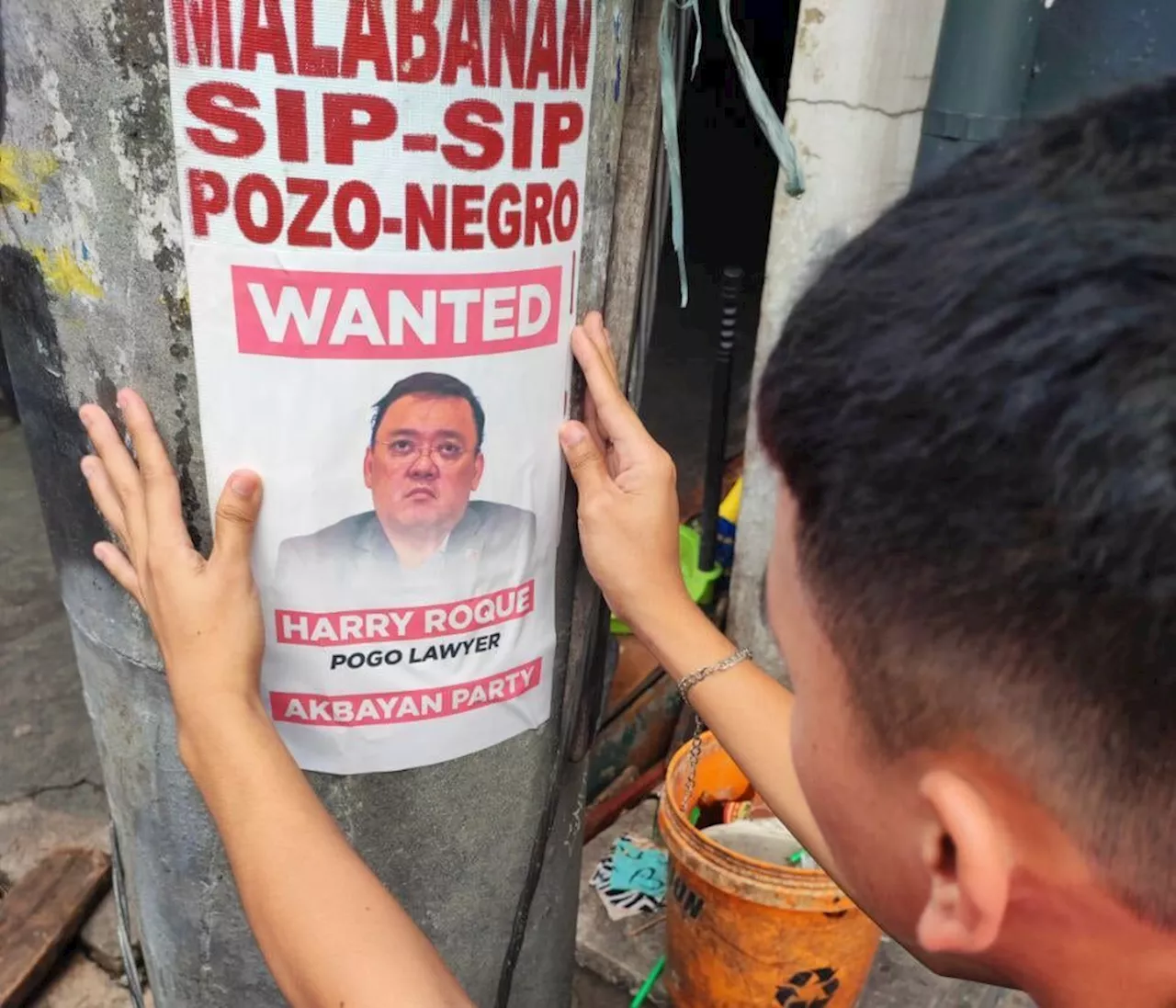 Akbayan spreads wanted posters of Harry Roque in Quezon City