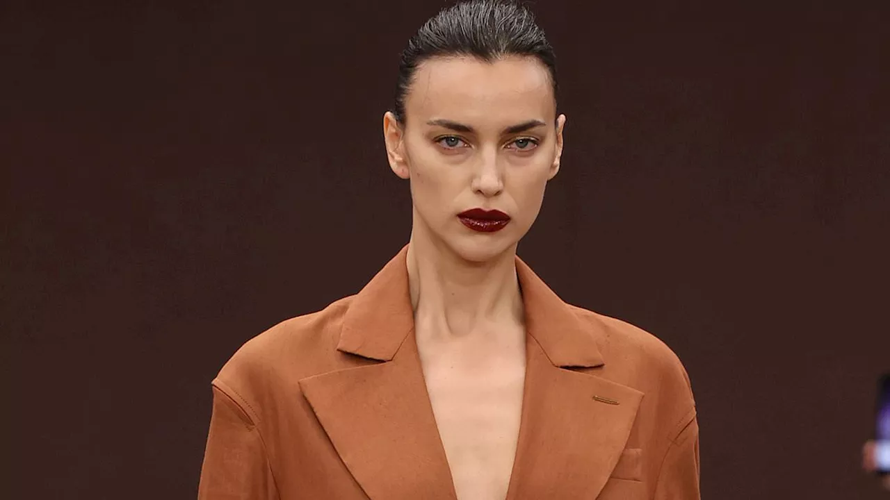 Irina Shayk goes braless beneath a longline tan coat while Amelia Gray Hamlin flashes her abs on the...