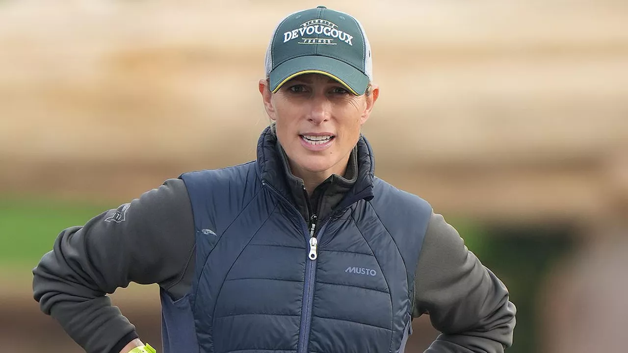 Zara Tindall braves rainy conditions as she wades through flooded fields at Blenheim International...