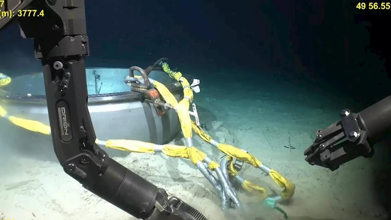 Eerie moment underwater drone robot picks through crumpled wreckage of imploded Titan sub in haunting new...