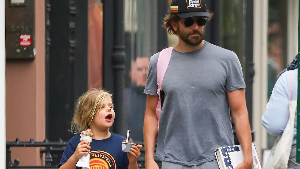 Bradley Cooper is a doting dad as he ties daughter Lea's, 7, shoelace