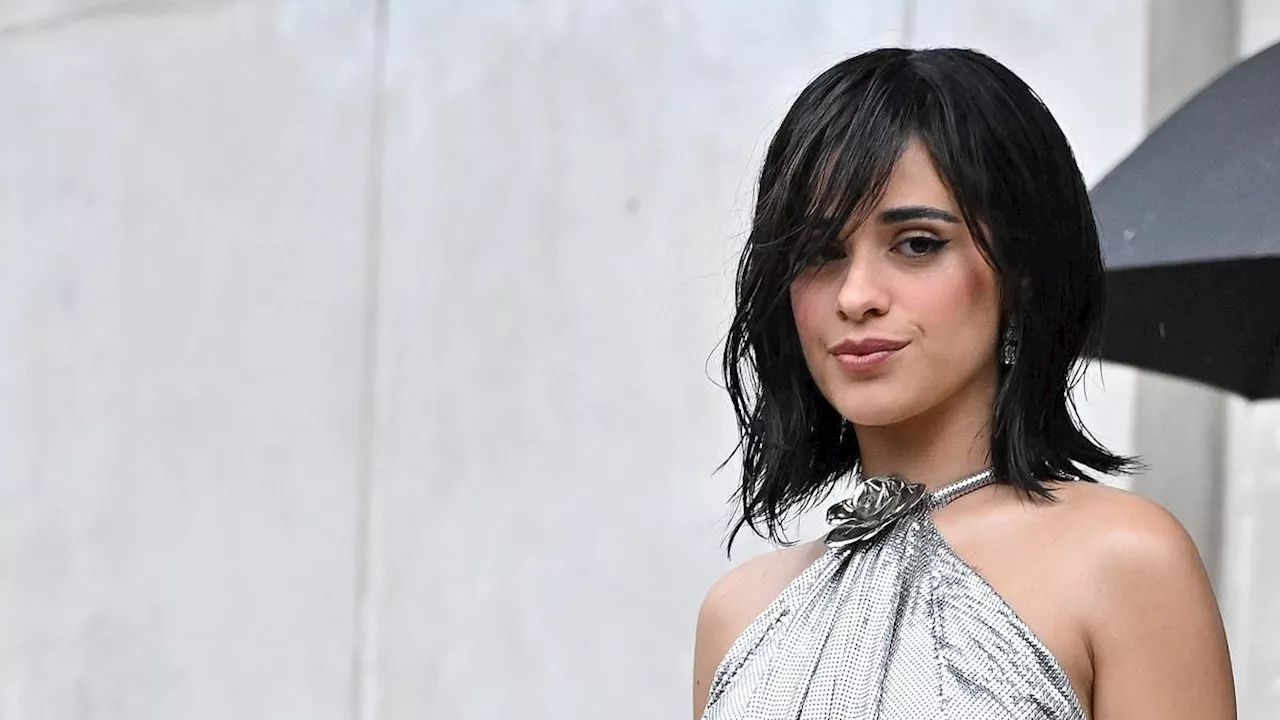 Camila Cabello wigs out while braving Paris thunderstorm in silver mini-dress at Rabanne fashion...