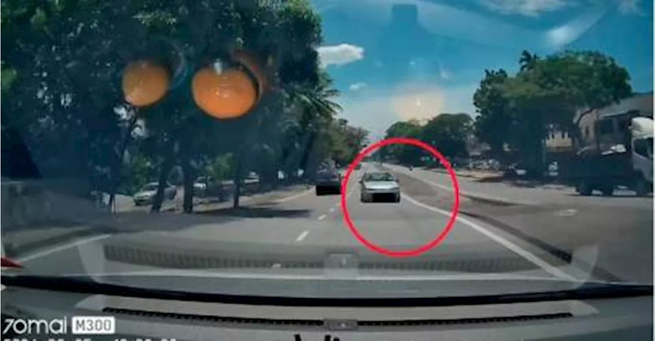 Man evades car driving against traffic on Penang road