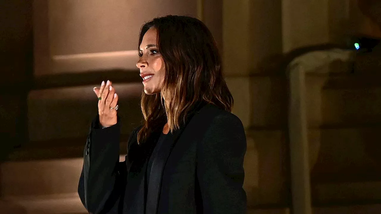 Victoria Beckham greets the star-studded audience at her Paris show