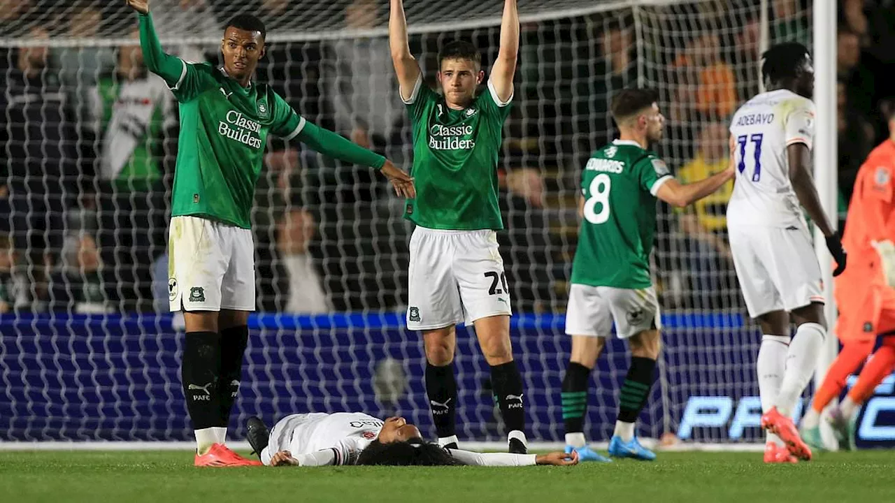 Ex-Man United star Tahith Chong collapses on the pitch during Luton's clash with Plymouth as medics...