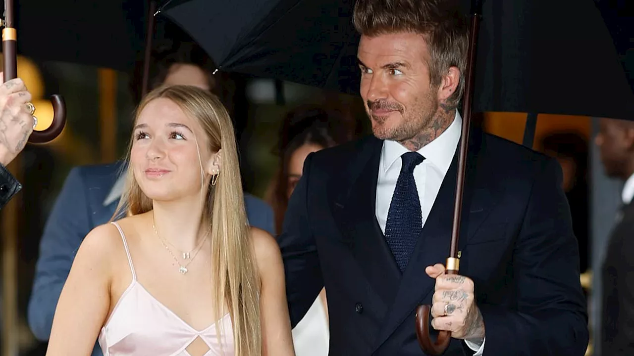 Victoria Beckham designed bespoke pink satin dress worn by teenage daughter Harper as they make...