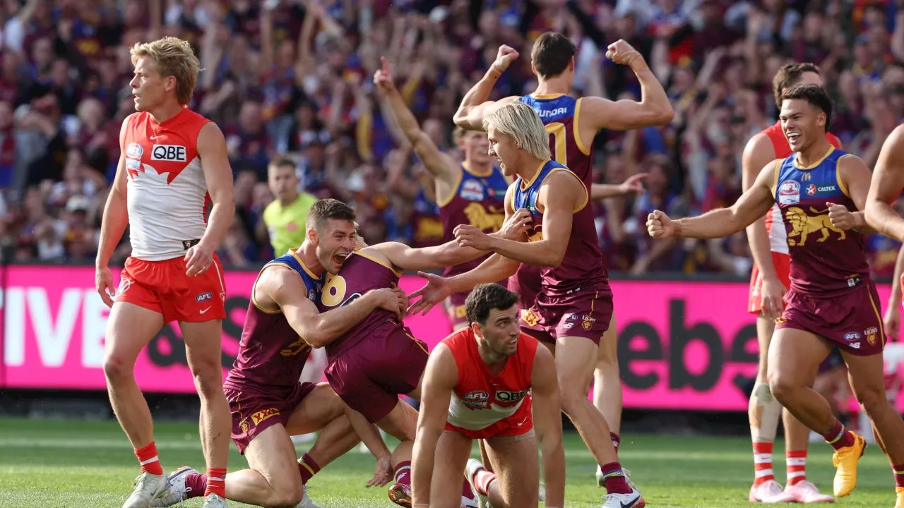 Brisbane Lions claim first AFL premiership in more than 20 years after thrashing Sydney Swans