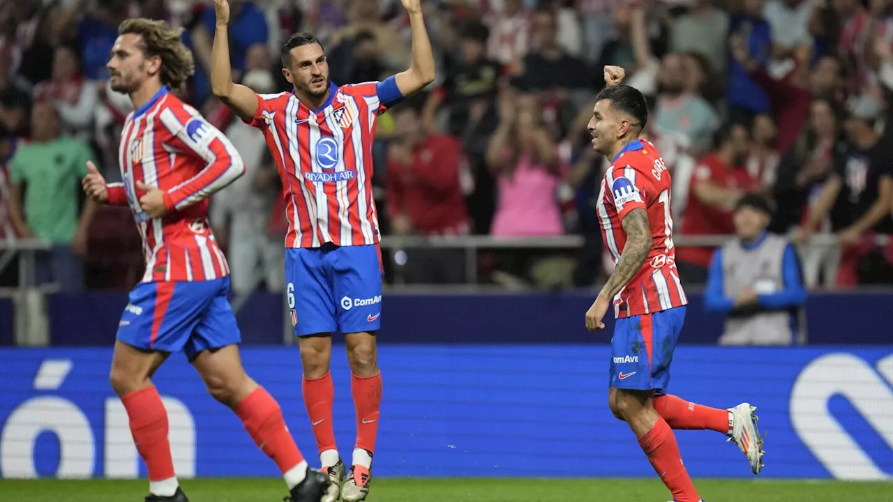 Atletico equalizes late against Madrid in derby interrupted after objects thrown on the field