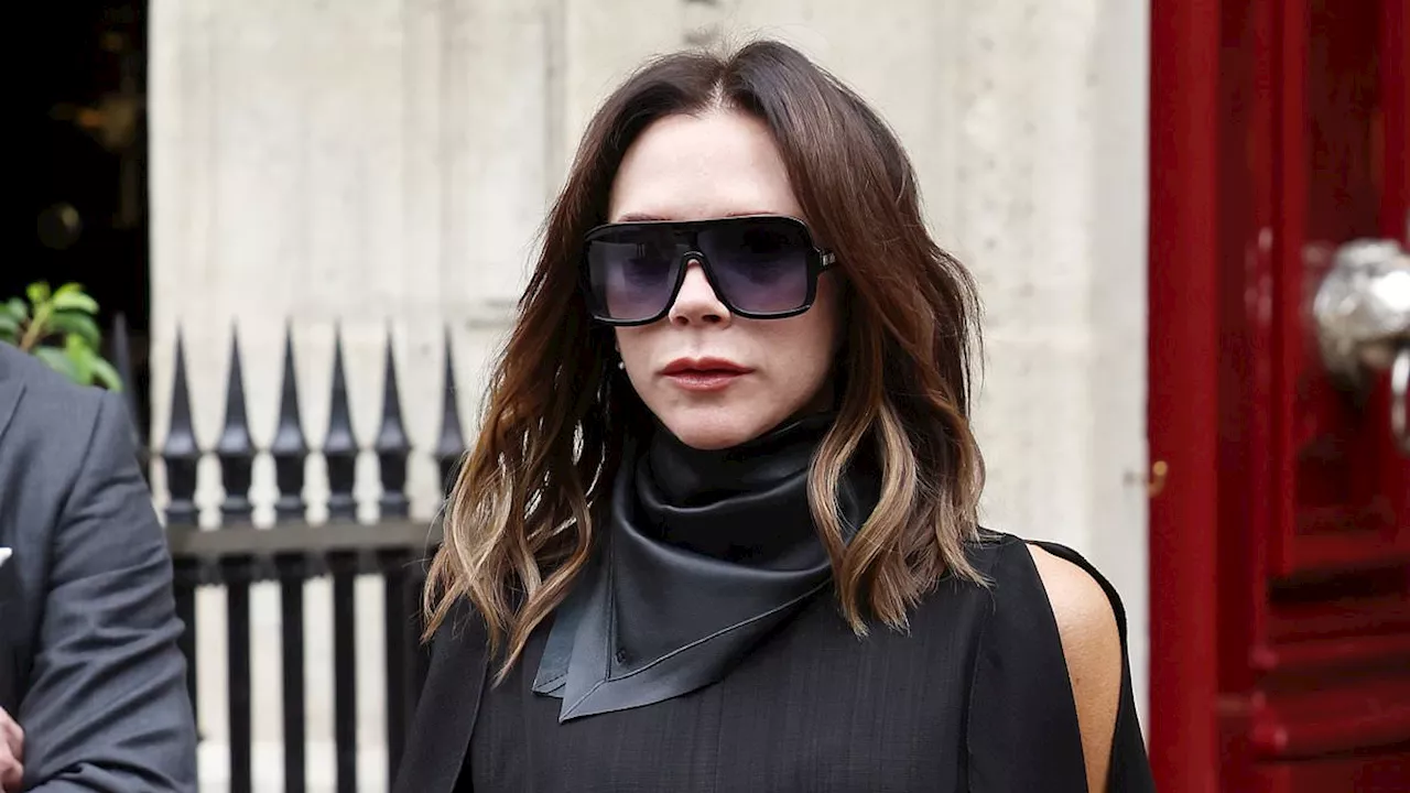 Victoria Beckham rocks a leggy black dress while her leather-clad husband David holds hands with...