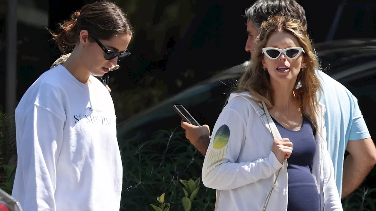 Pregnant Katherine Schwarzenegger showcases burgeoning baby bump on outing with sister Christina