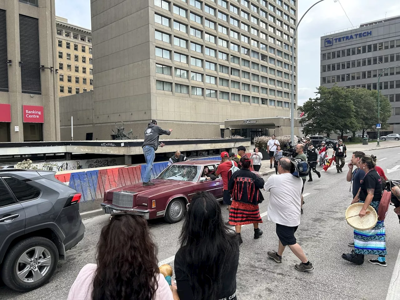 Car drives through police protest in Winnipeg, driver confronted