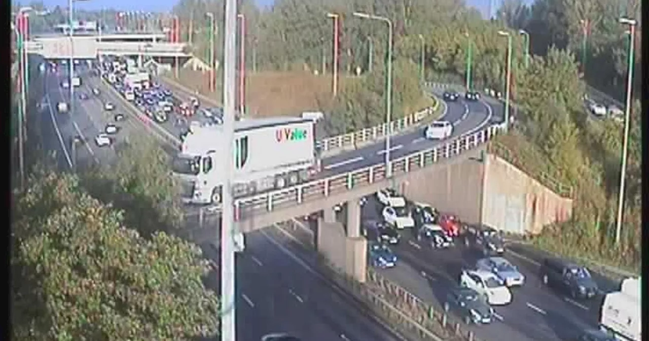 M60 crash LIVE updates as drivers face SIX-MILE queues with lane closed