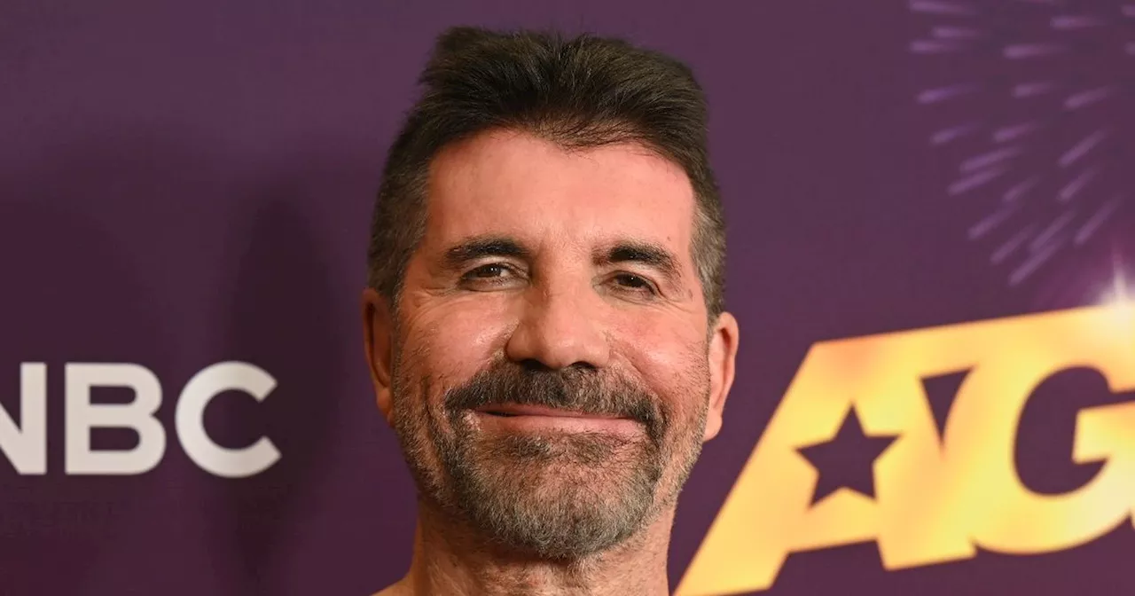 Proud dad Simon Cowell joined by lookalike son Eric, 10, on red carpet