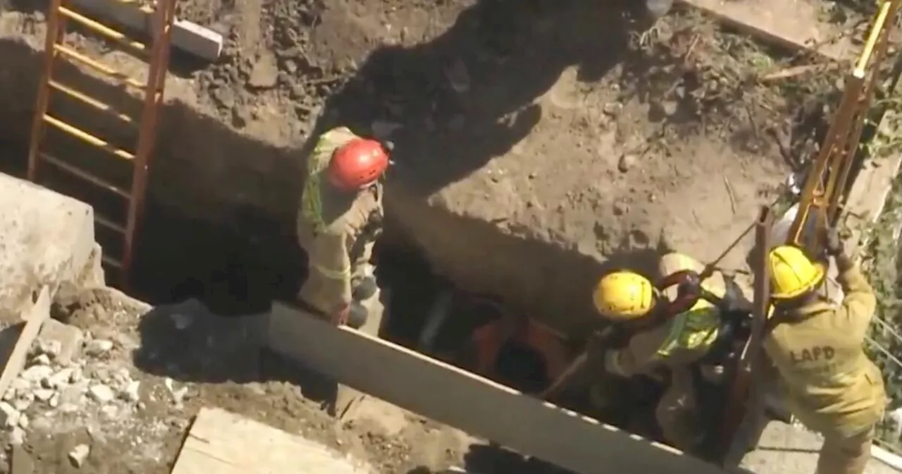 Firefighters work to rescue man buried for hours in trench in Los Feliz