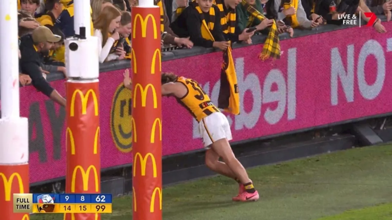 Nick Watson cramps during celebrations after Hawthorn’s elimination final win over Western Bulldogs