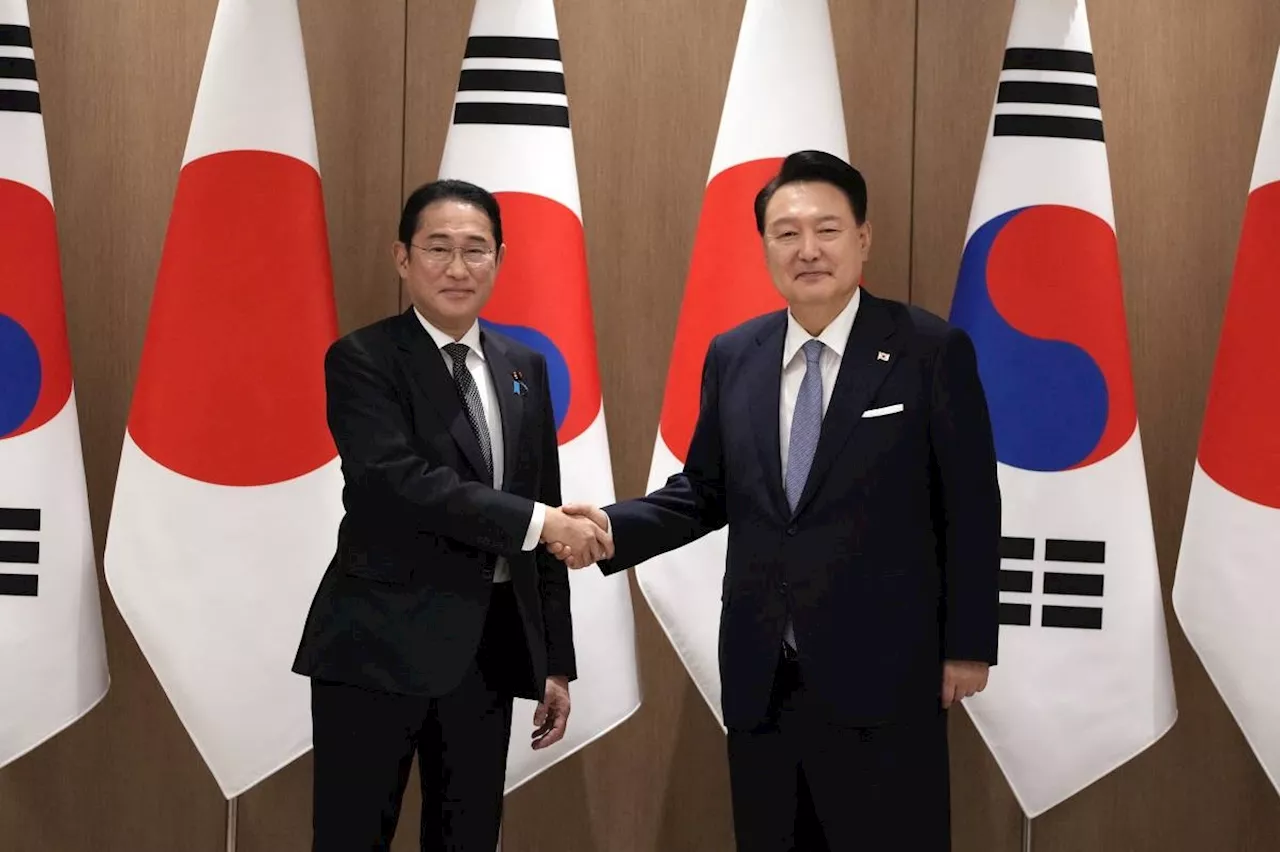 Outgoing Japan PM promises warmer ties with Seoul