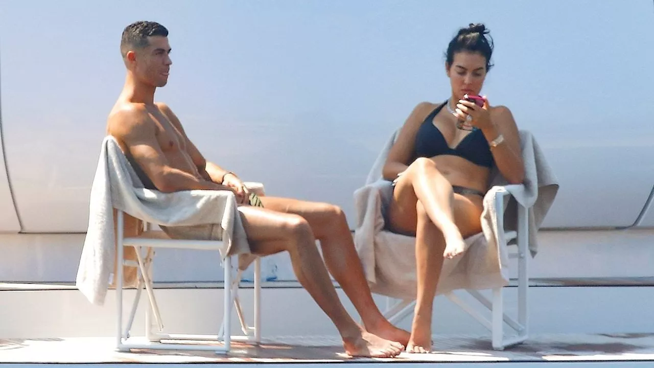 Georgina Rodriguez cheekily flashes her bottom as shirtless Cristiano Ronaldo rinses off after a...