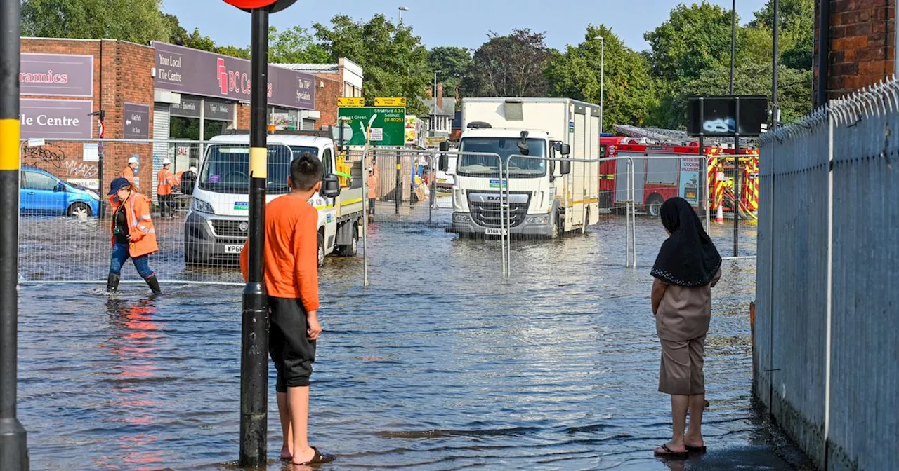 Busy street left 'like a river' after burst water main causes chaos