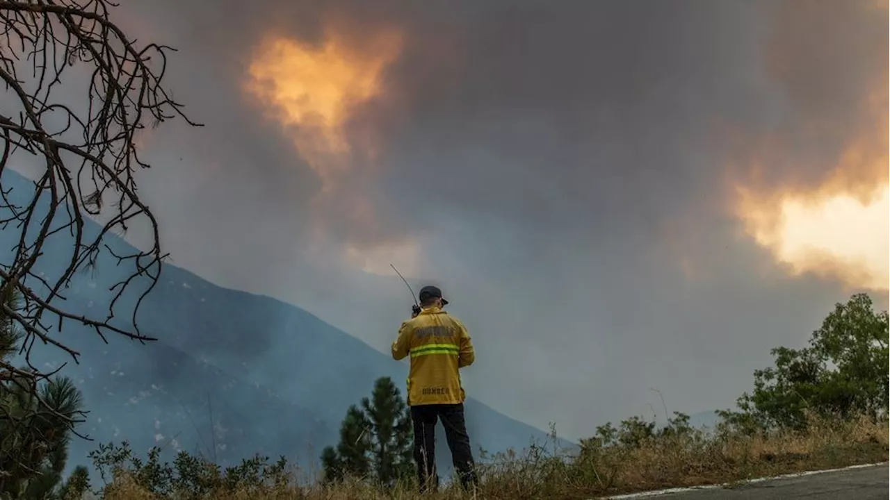 Wildfire east of LA threatens tens of thousands of homes and forces evacuations