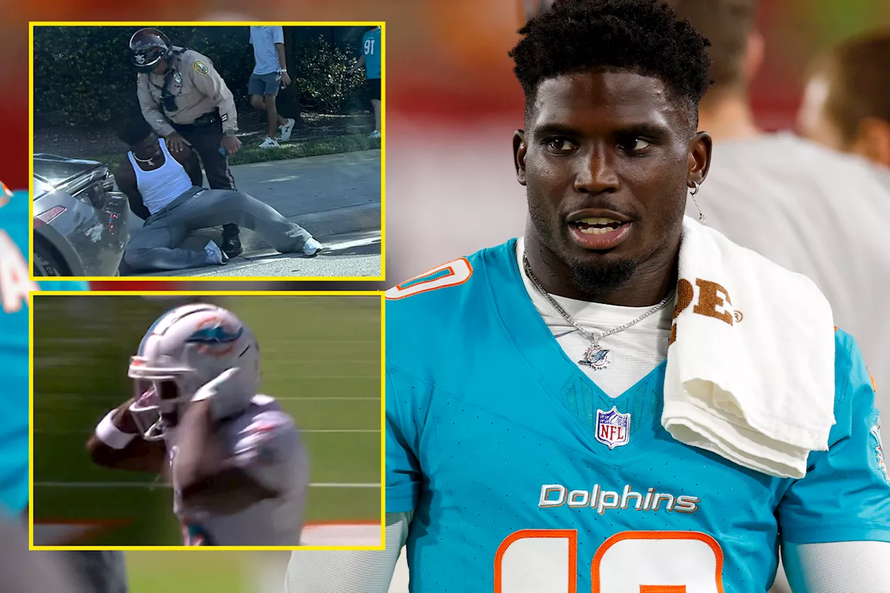 NFL star Tyreek Hill scores Miami Dolphins touchdown with ‘handcuff’ celebration hours after being det...