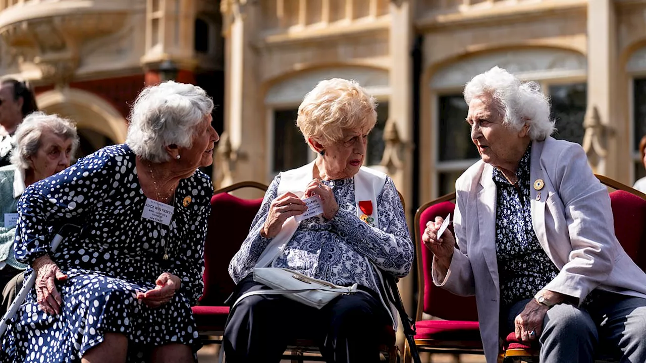 Codebreaking Second World War veterans smile as they reunite at Bletchley Park