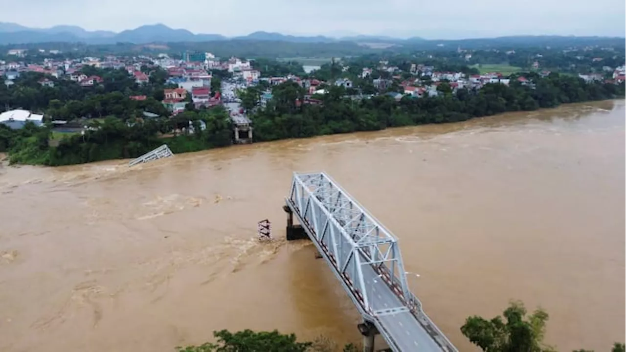 Bridge collapses as more rain falls in Vietnam and storm deaths rise to 21