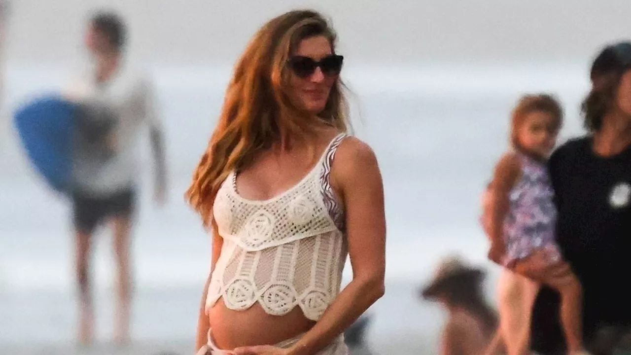 Gisele Bundchen, 44, flashes her baby bump as she enjoys a beach day with partner Joaquim Valente in...