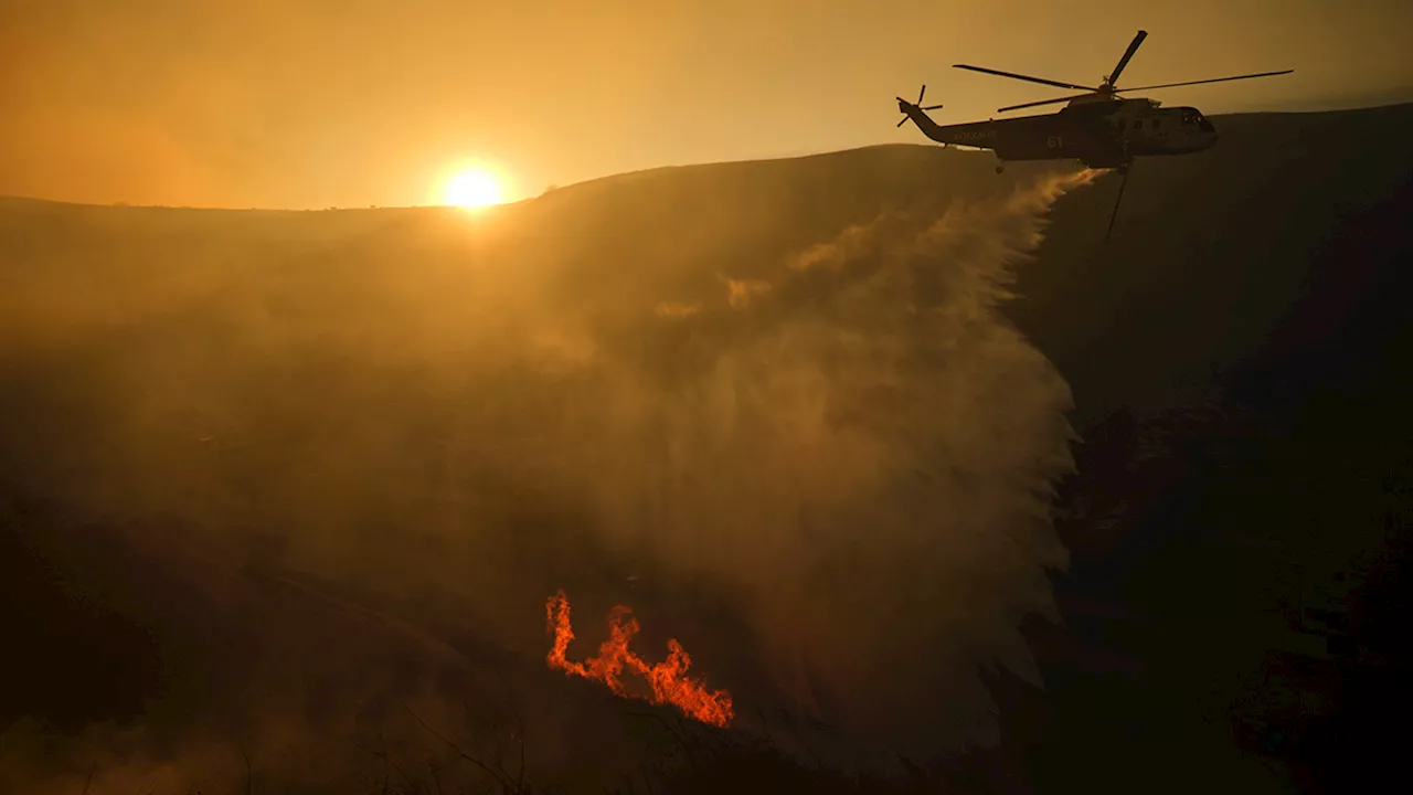 Fire officials plead for people to not fly drones over wildfire-ravaged areas of Southern California