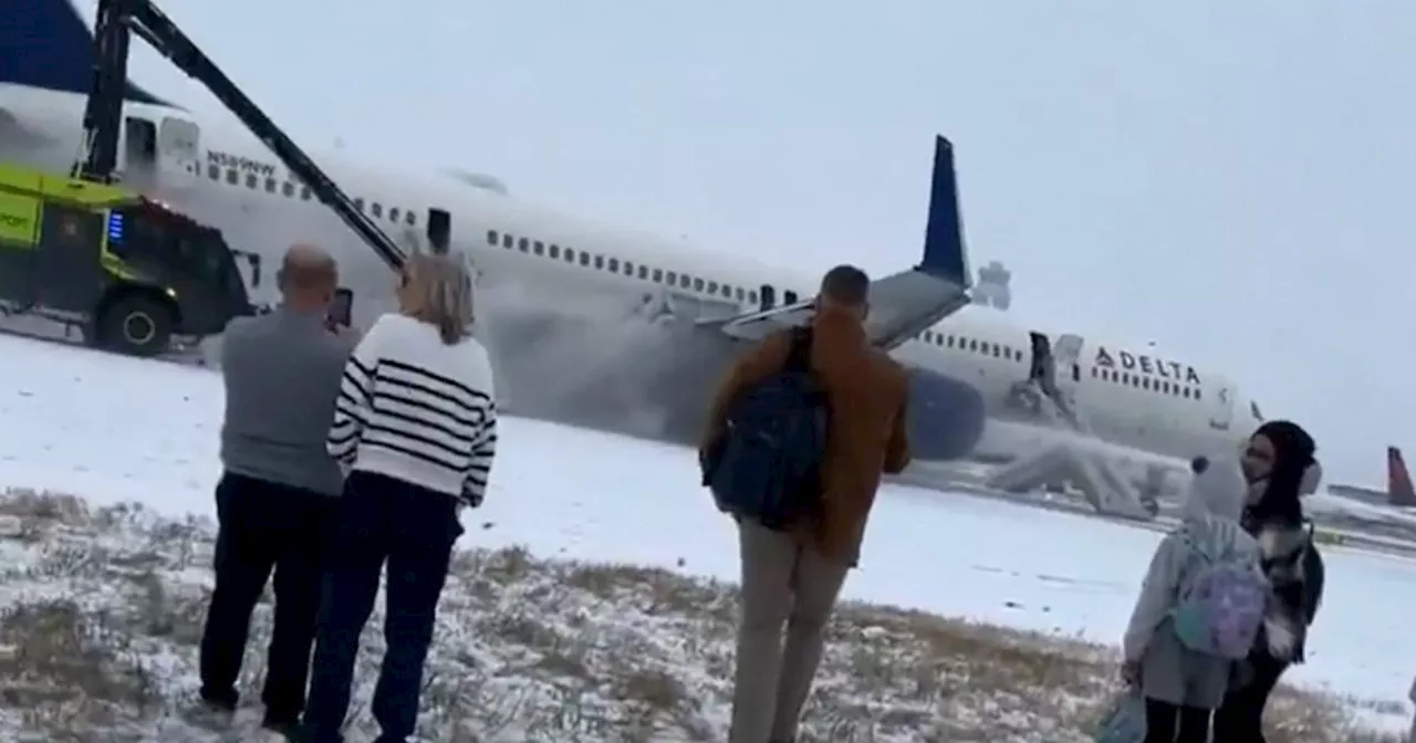 Over 200 plane passengers evacuate on slides and four injured