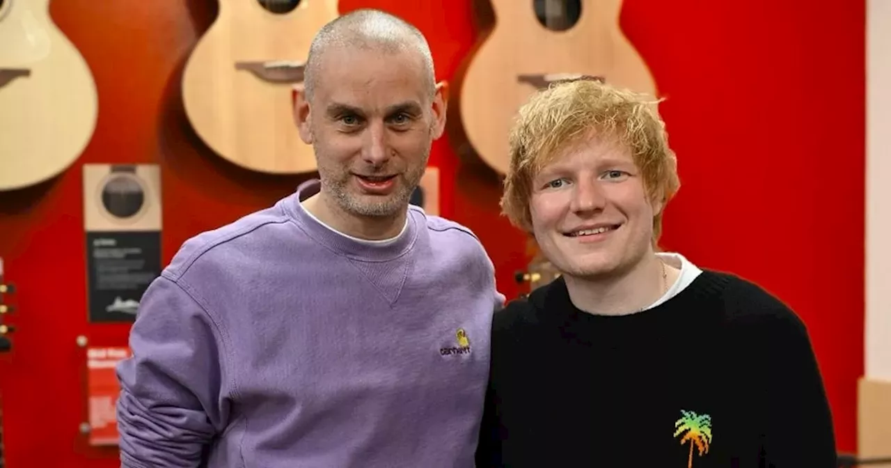 Ed Sheeran picks up new guitar on visit to Belfast music store