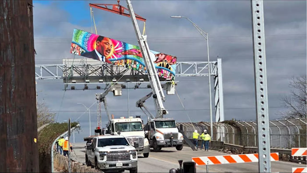 City crews brave cold, strong winds to install new artwork on San Antonio bridge