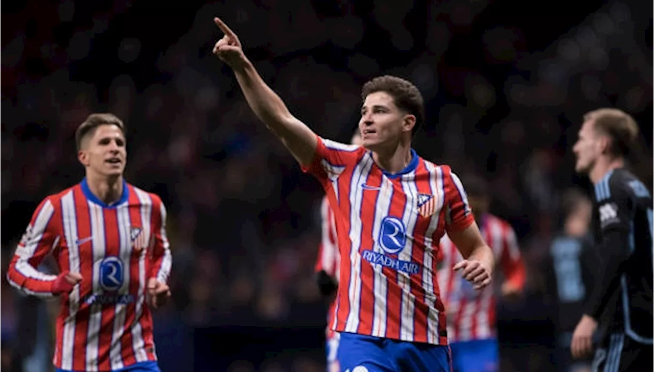 Atletico Madrid wins record 14th game in a row to lead Spanish league at halfway stage