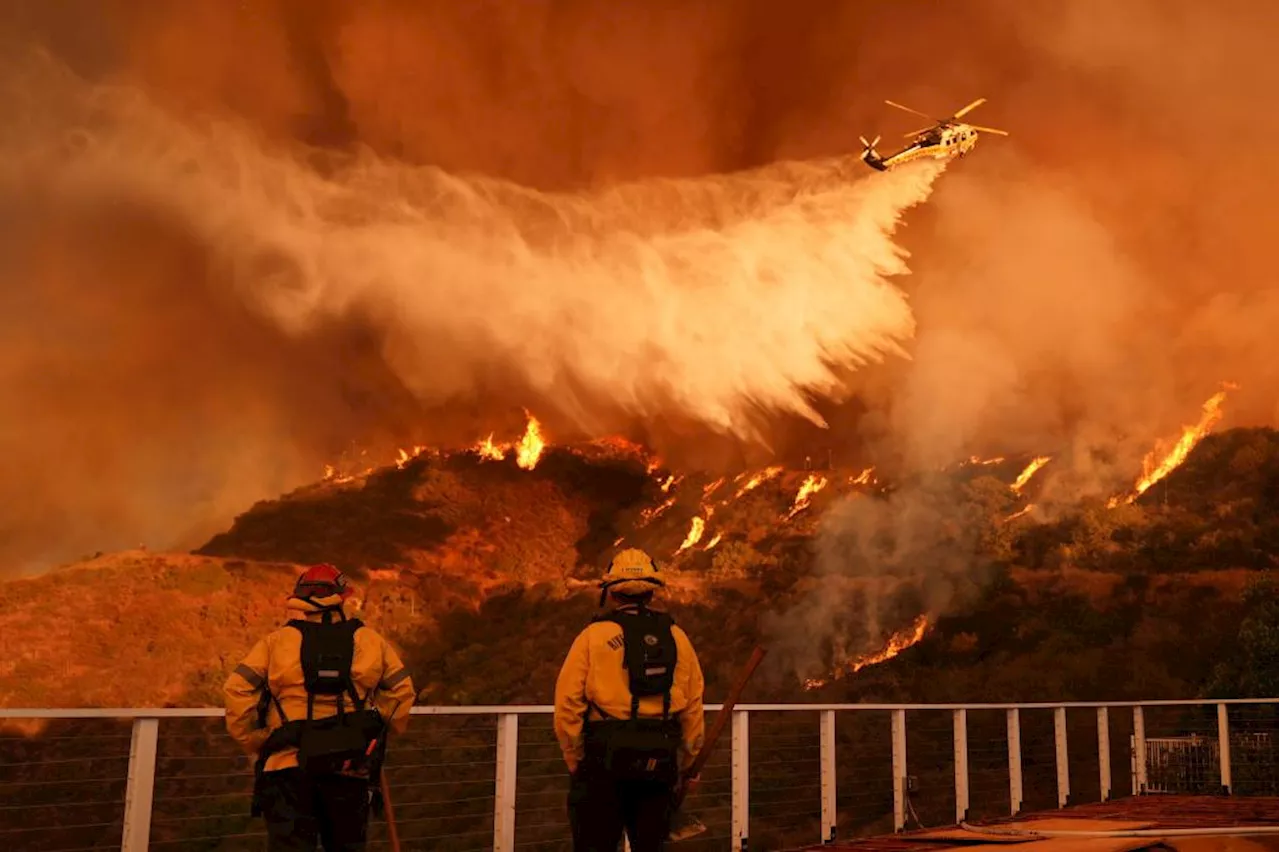 24 dead as fire crews try to corral Los Angeles blazes before winds return this week