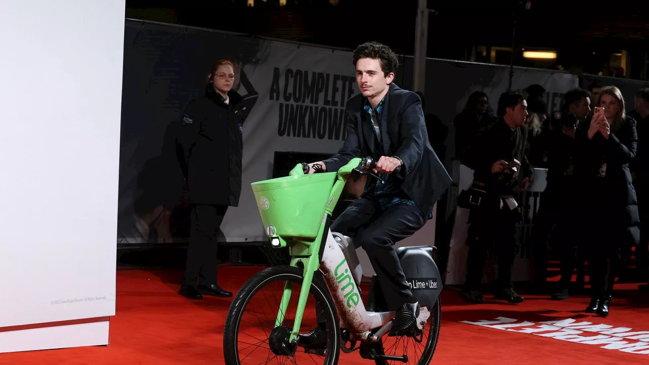 Timothée Chalamet Bikes Onto the Red Carpet for 'A Complete Unknown' Premiere