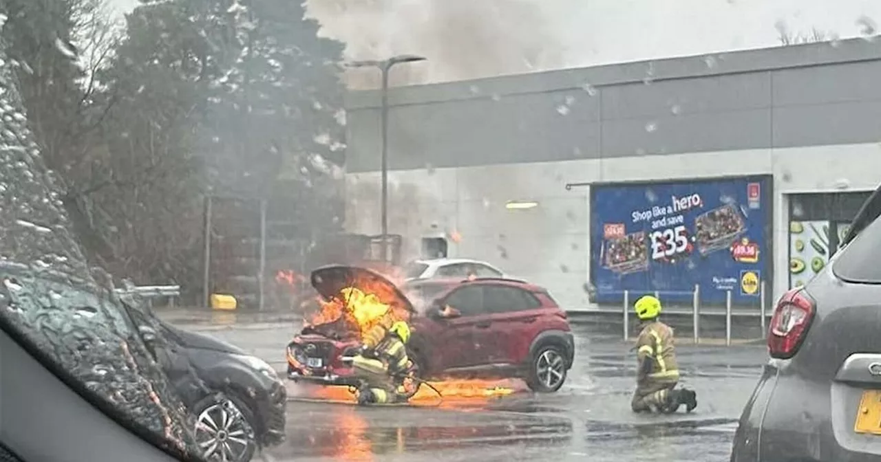 Flames rip through vehicle in car park as fire crews race to scene