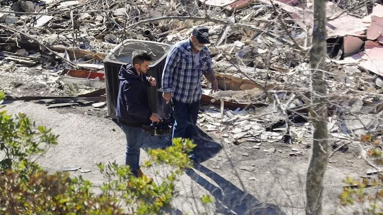 Emotional Mel Gibson surveys the smoldering remains of his Malibu house after firefighter made...