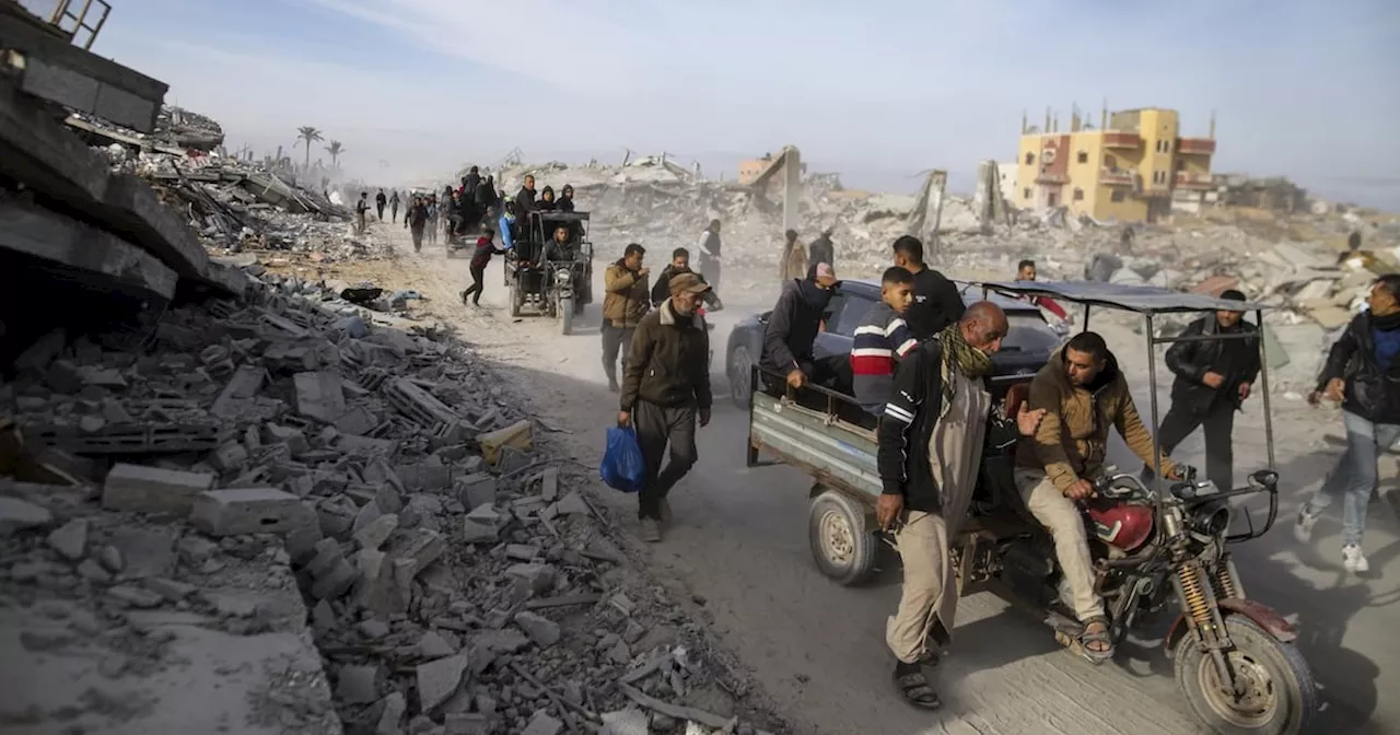 Palestinians trek across rubble to return to their homes as Gaza ceasefire takes hold