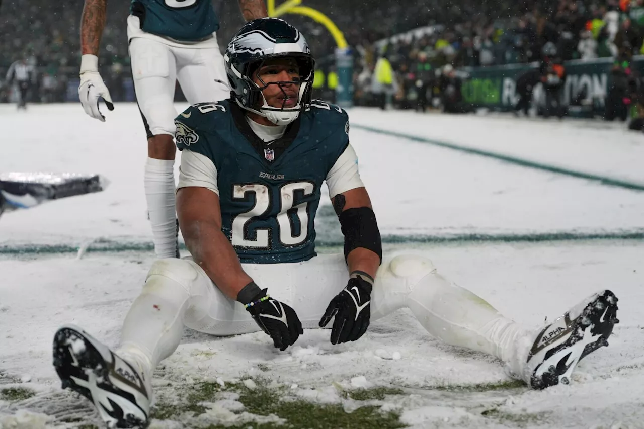 Barkley runs for 78 and 62-yard TDs in the snow and Eagles beat Rams 28-22 to head to NFC title game