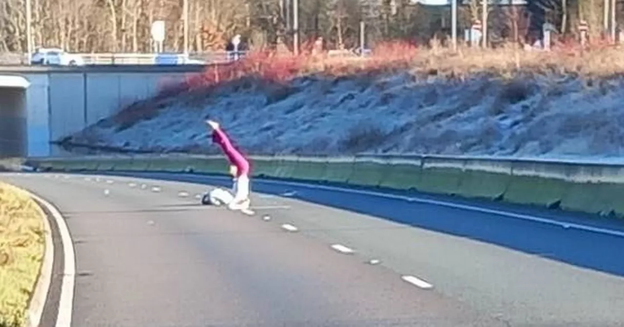 Woman Practices Yoga Amidst A555 Flooding Near Manchester Airport