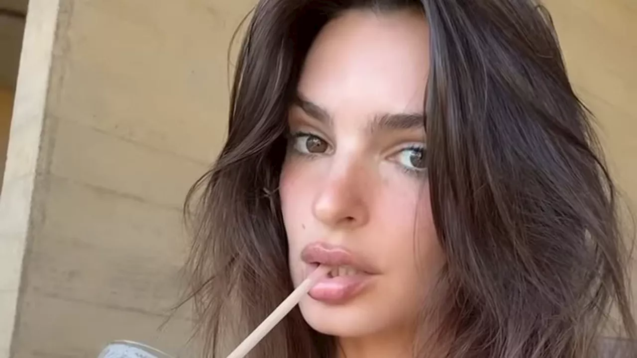 Emily Ratajkowski dances around in red hot thong bikini as wild internet theory links her to Austin...