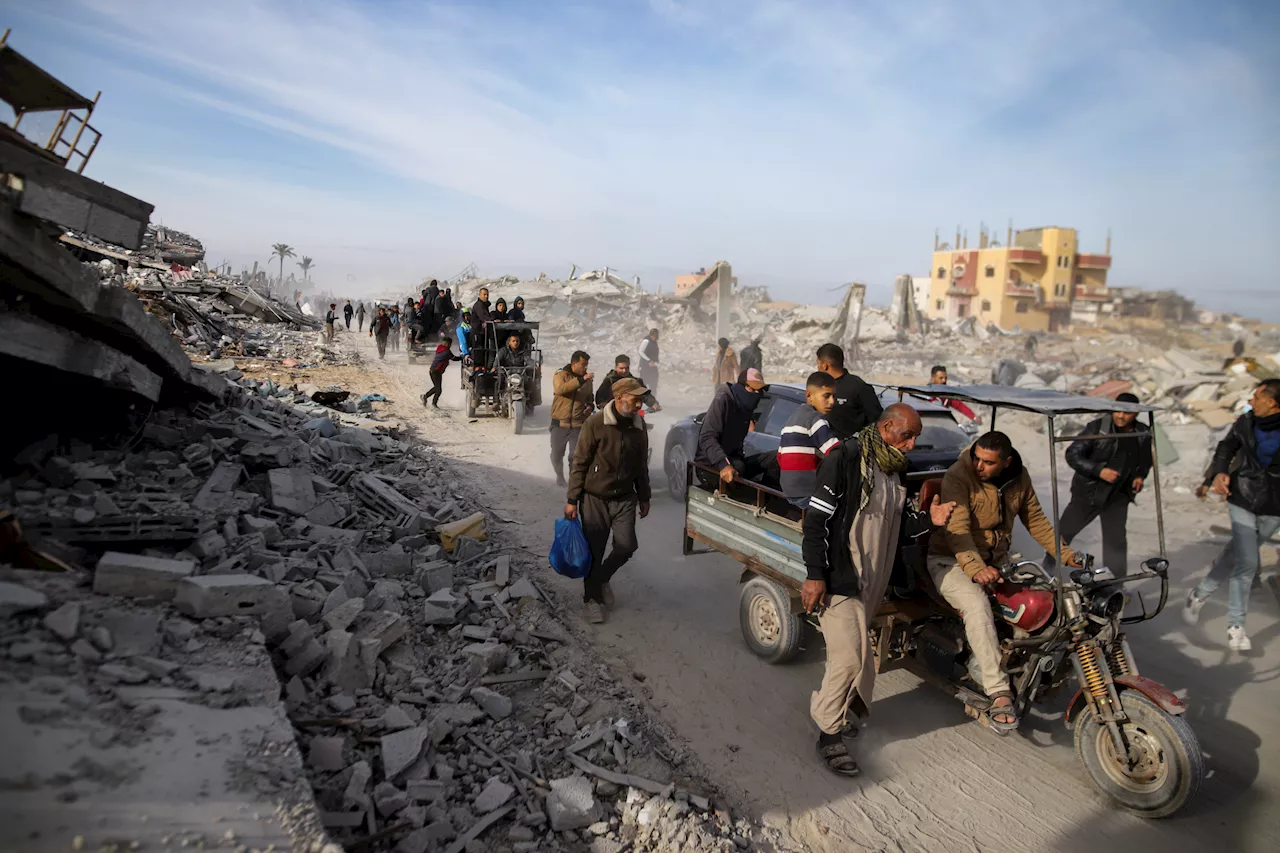 Palestinians trek across rubble to return to their homes as Gaza ceasefire takes hold