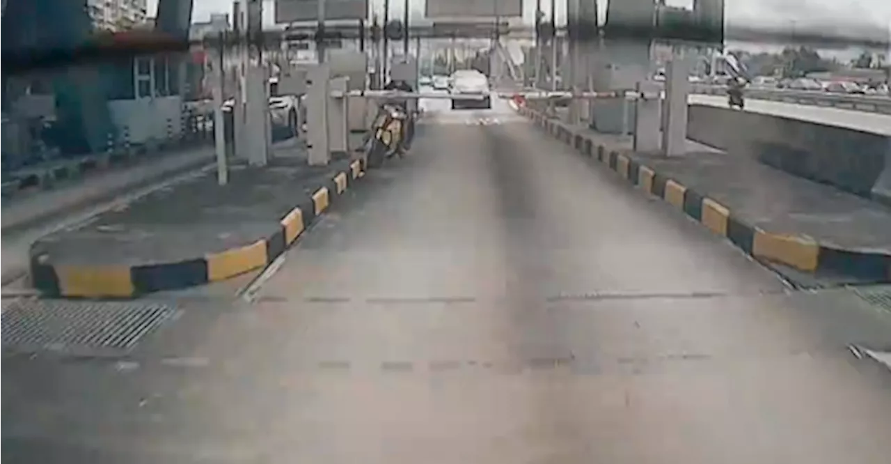 Motorcyclist crashes into boom gate after driving in car lane