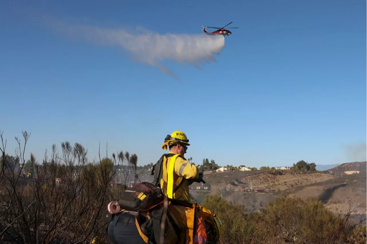 Brush fire forces evacuations in Poway, California