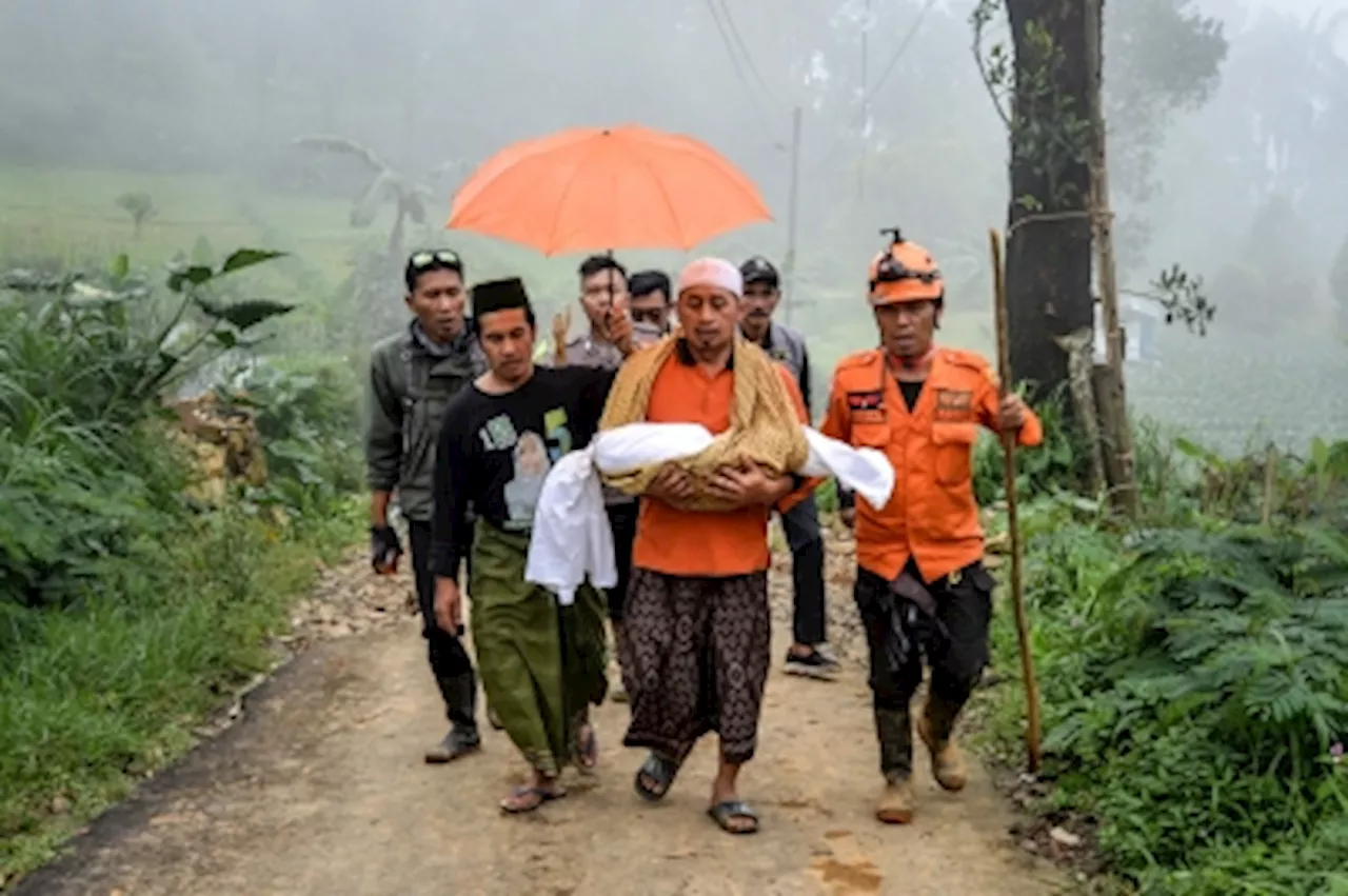 Indonesia landslide death toll rises to 21 as rescuers dig for survivors