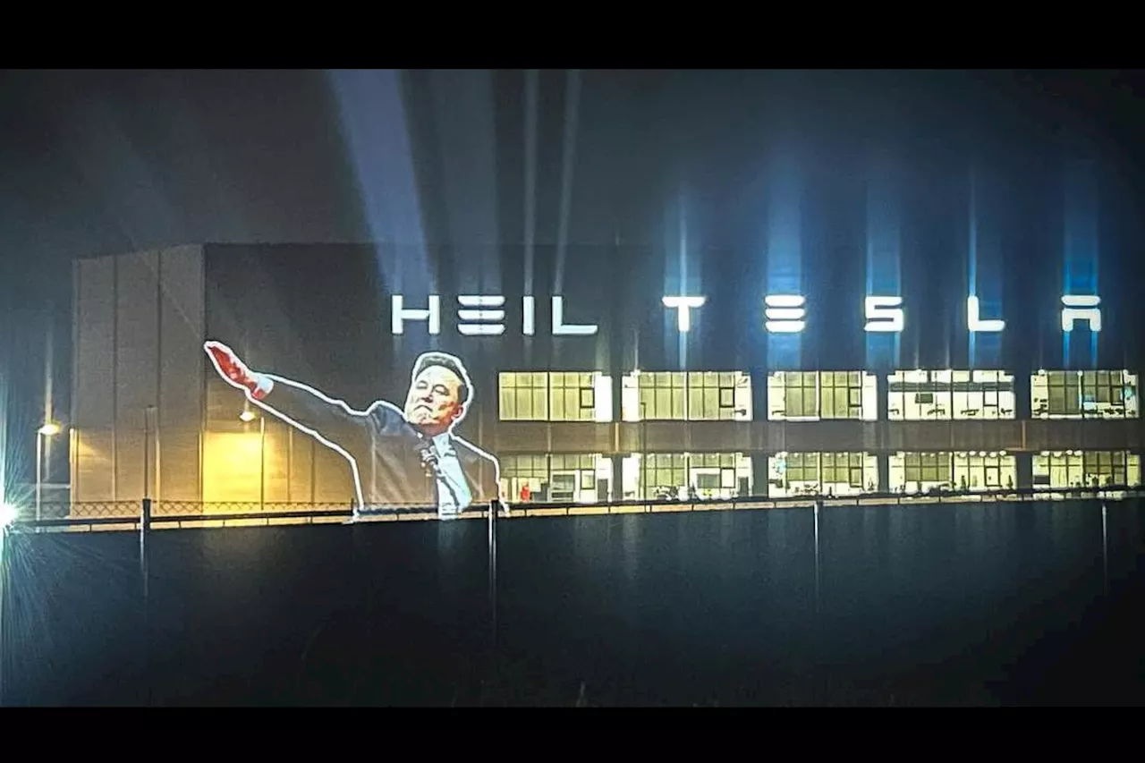 Elon Musk's Gesture Projected Onto Tesla Factory Alongside 'Heil Tesla'