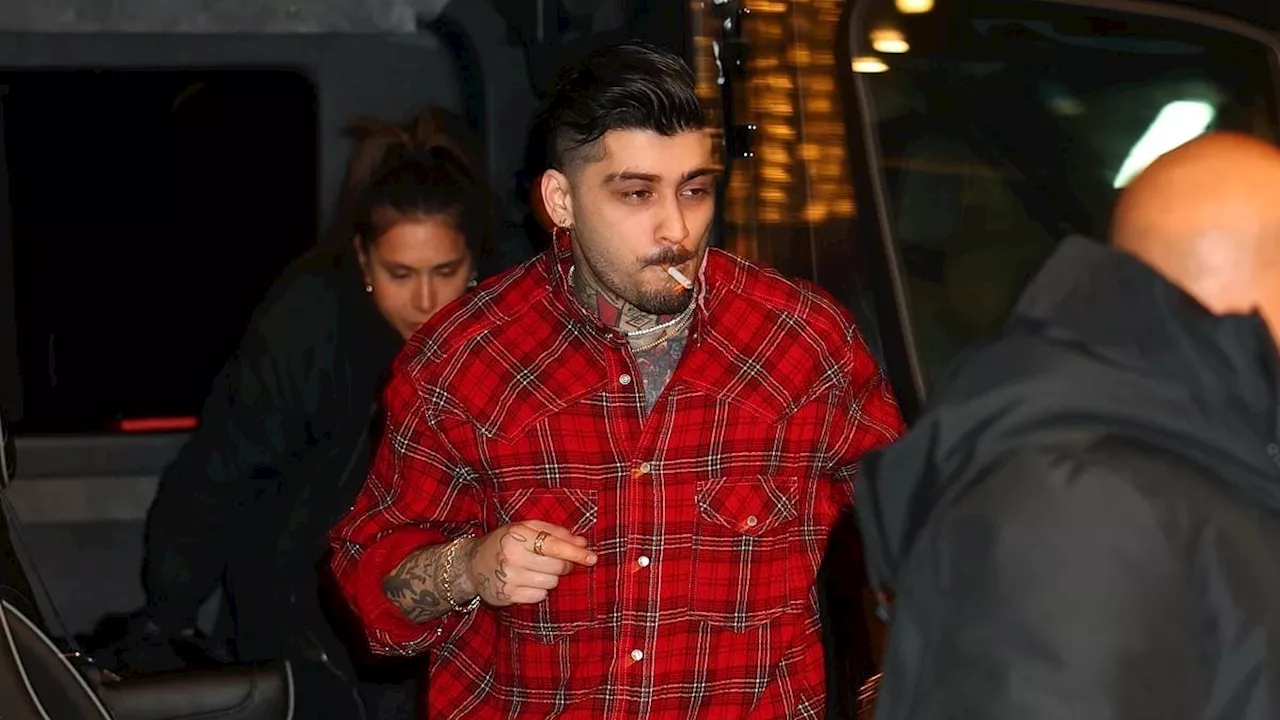 Zayn Malik enjoys a cigarette after his concert in New York City on rare sighting