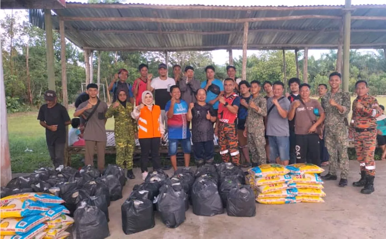 Sabah firefighters brave floodwaters to send food baskets to victims